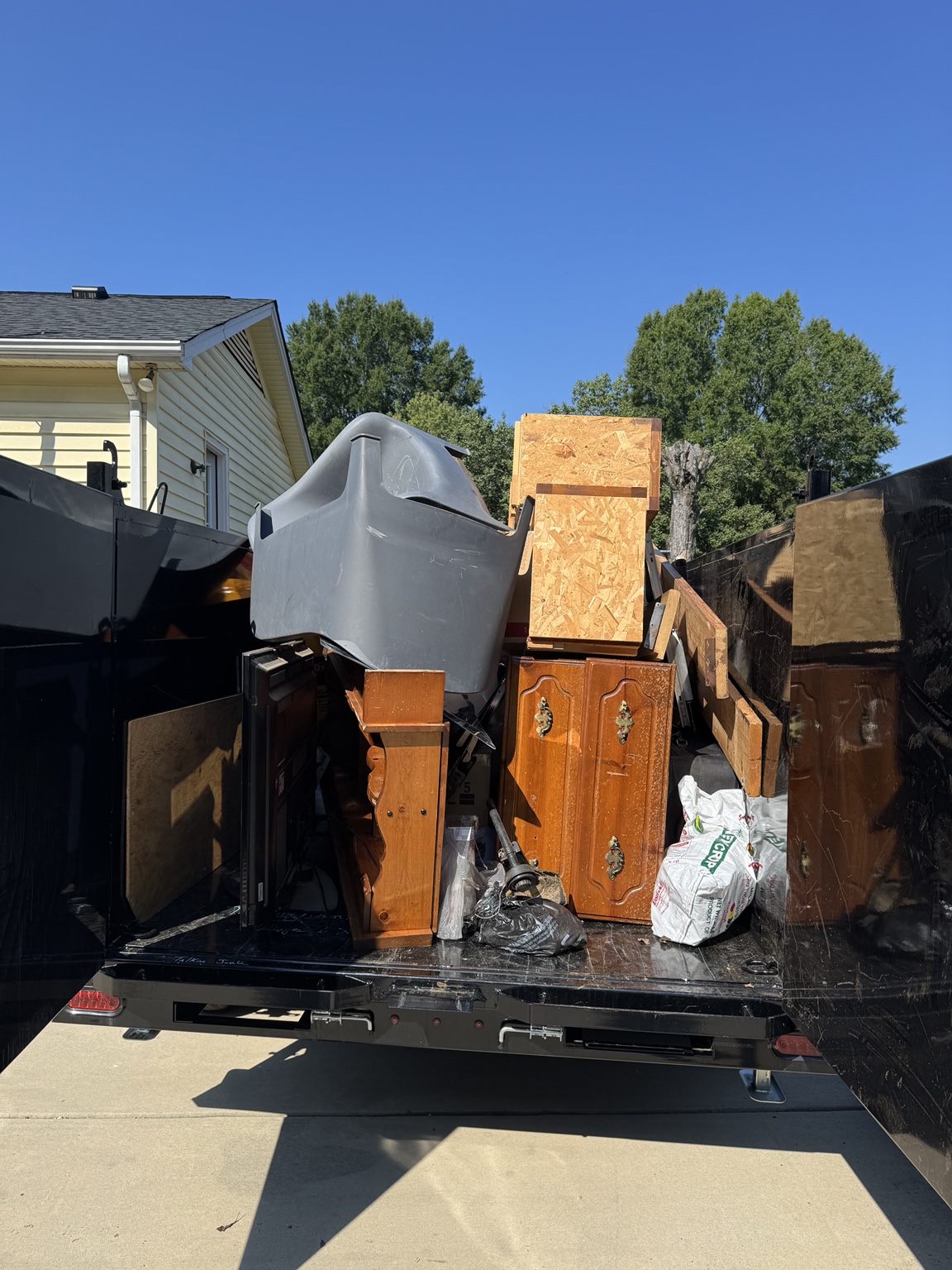 Furniture and household junk loaded into a removal trailer