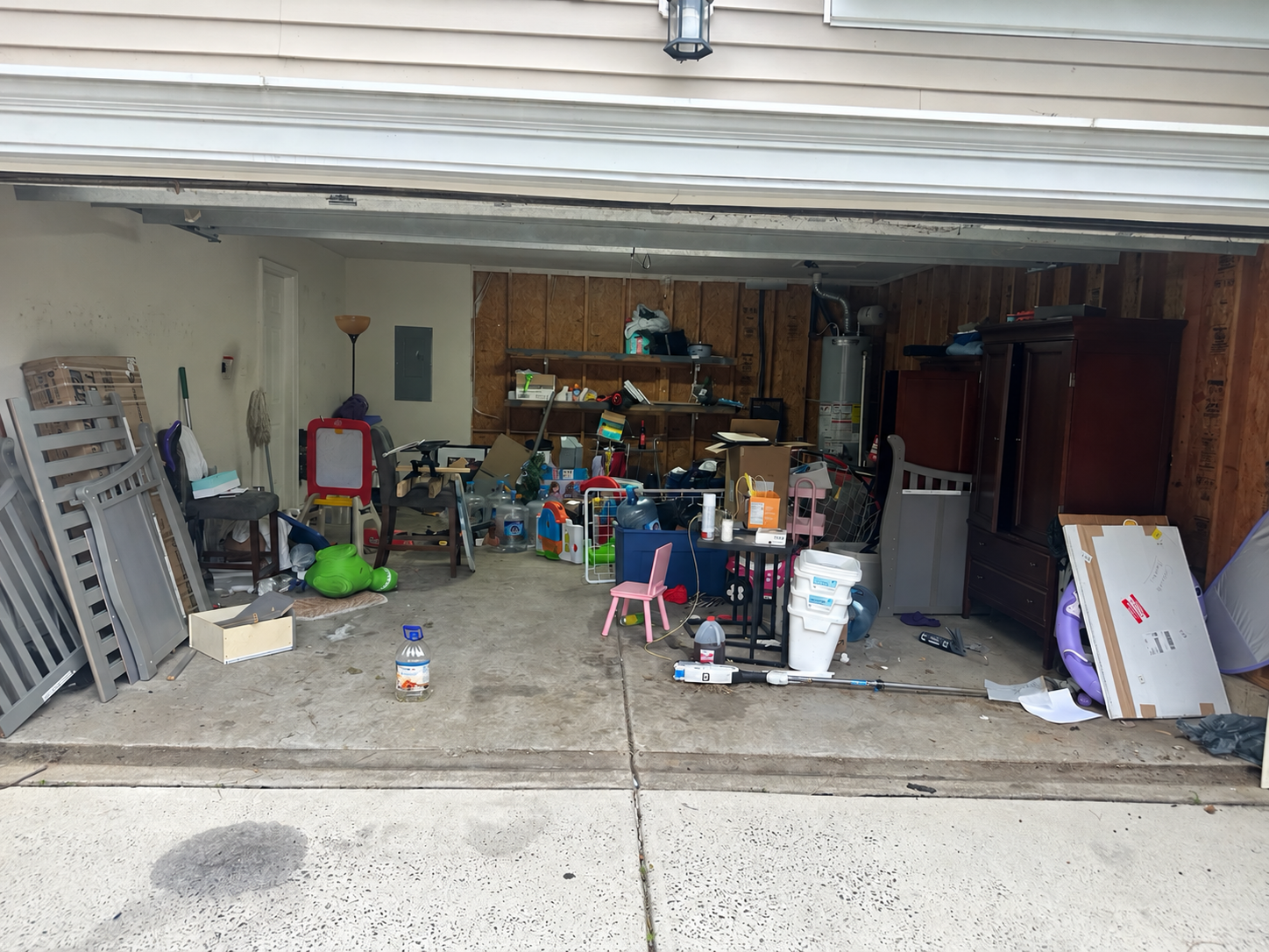 Cluttered garage before a Talking Junk cleanout