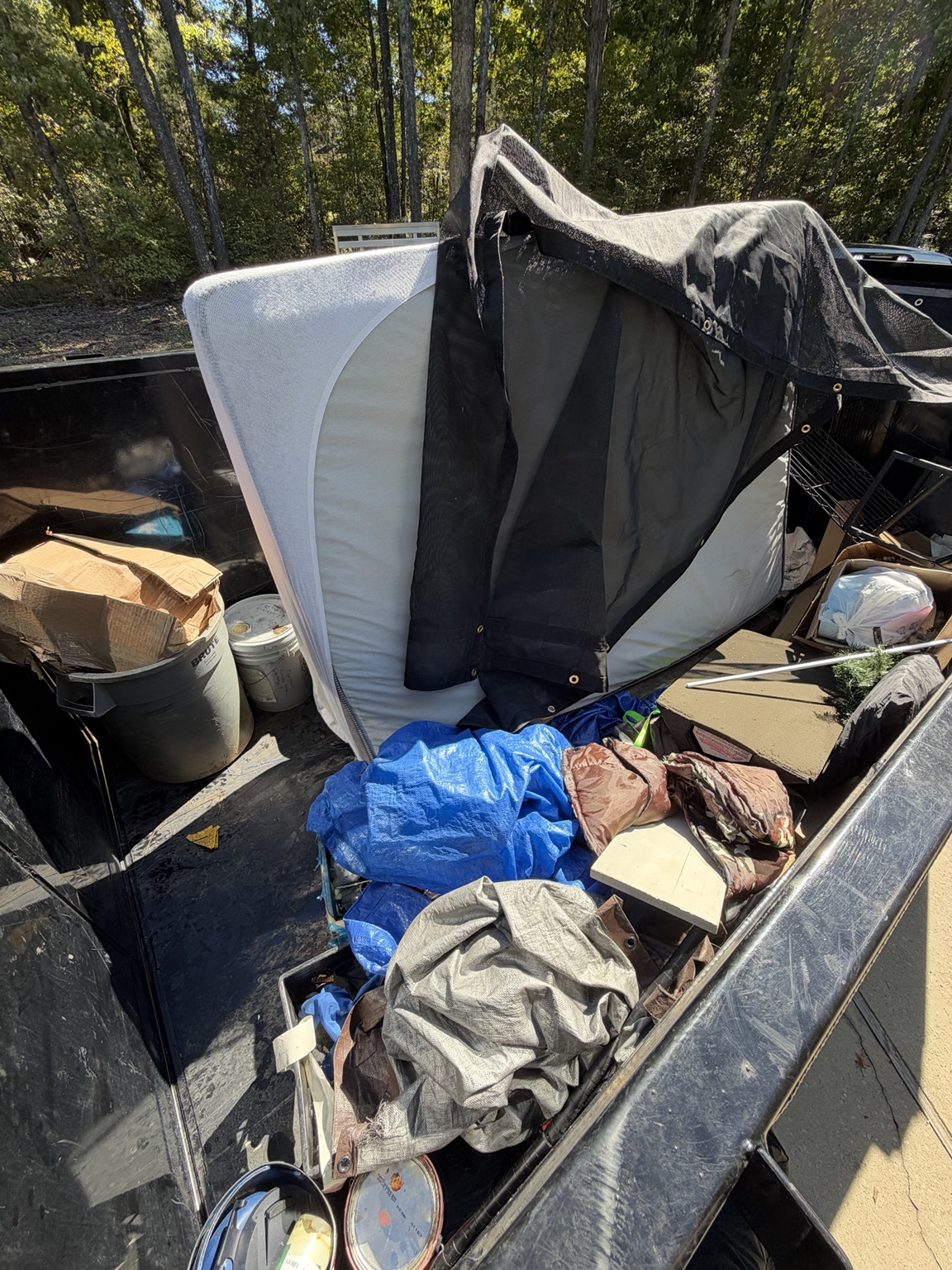 Mattress and household junk loaded into the Talking Junk trailer